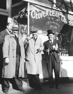 4 men standing outside Cloverleaf historical black and white